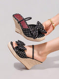 5 media show black polka dot wedge mule sandals with wide front bow strap, slim instep slip strap, burgundy insole, high braided jute espadrille wedge platform and brown outsole. image 2