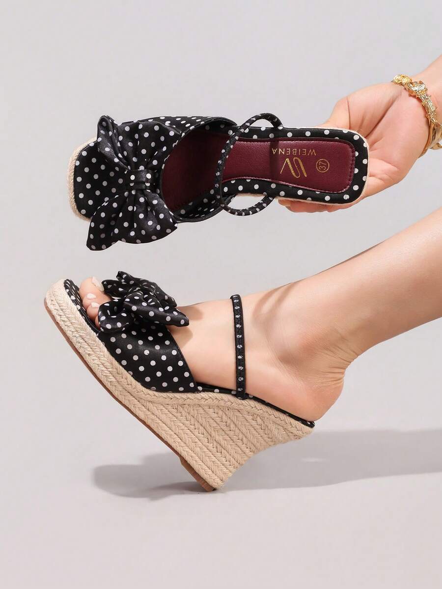 5 media show black polka dot wedge mule sandals with wide front bow strap, slim instep slip strap, burgundy insole, high braided jute espadrille wedge platform and brown outsole. image 4