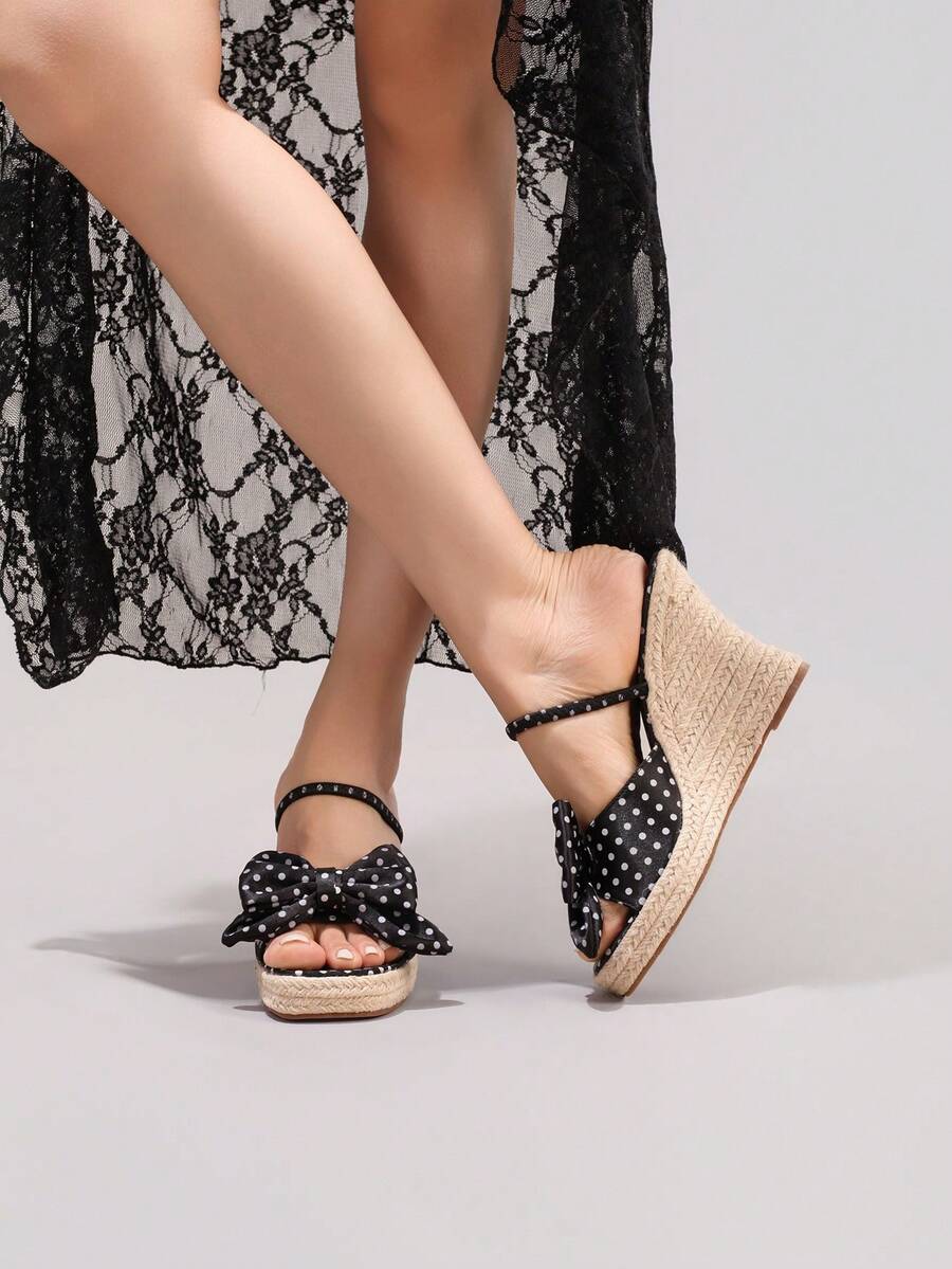 5 media show black polka dot wedge mule sandals with wide front bow strap, slim instep slip strap, burgundy insole, high braided jute espadrille wedge platform and brown outsole. image 5