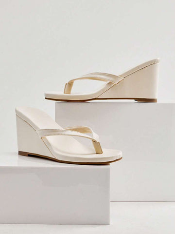 Cream thong wedge sandal studio pair side view with tan outsole edge