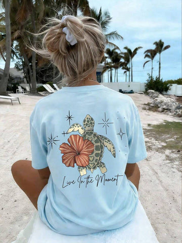 Back model view of baby blue turtle floral graphic tee with Live In the Moment print