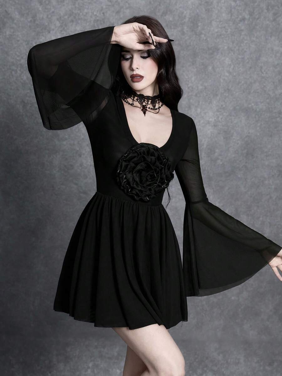 Front detail of black gothic dress showing deep V neckline and dimensional rose appliqué