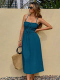 Teal tie-front midi sundress with ruffle trim on pebble patio