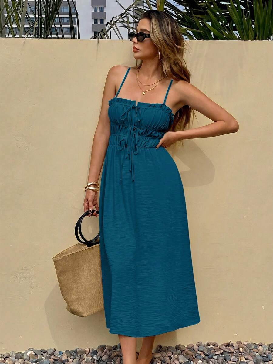 Teal tie-front midi sundress with ruffle trim on pebble patio
