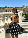 Shop a polka dot halter mini dress in coffee or blue. A chic A line summer dress for vacations, weekend getaways, and casual outings.