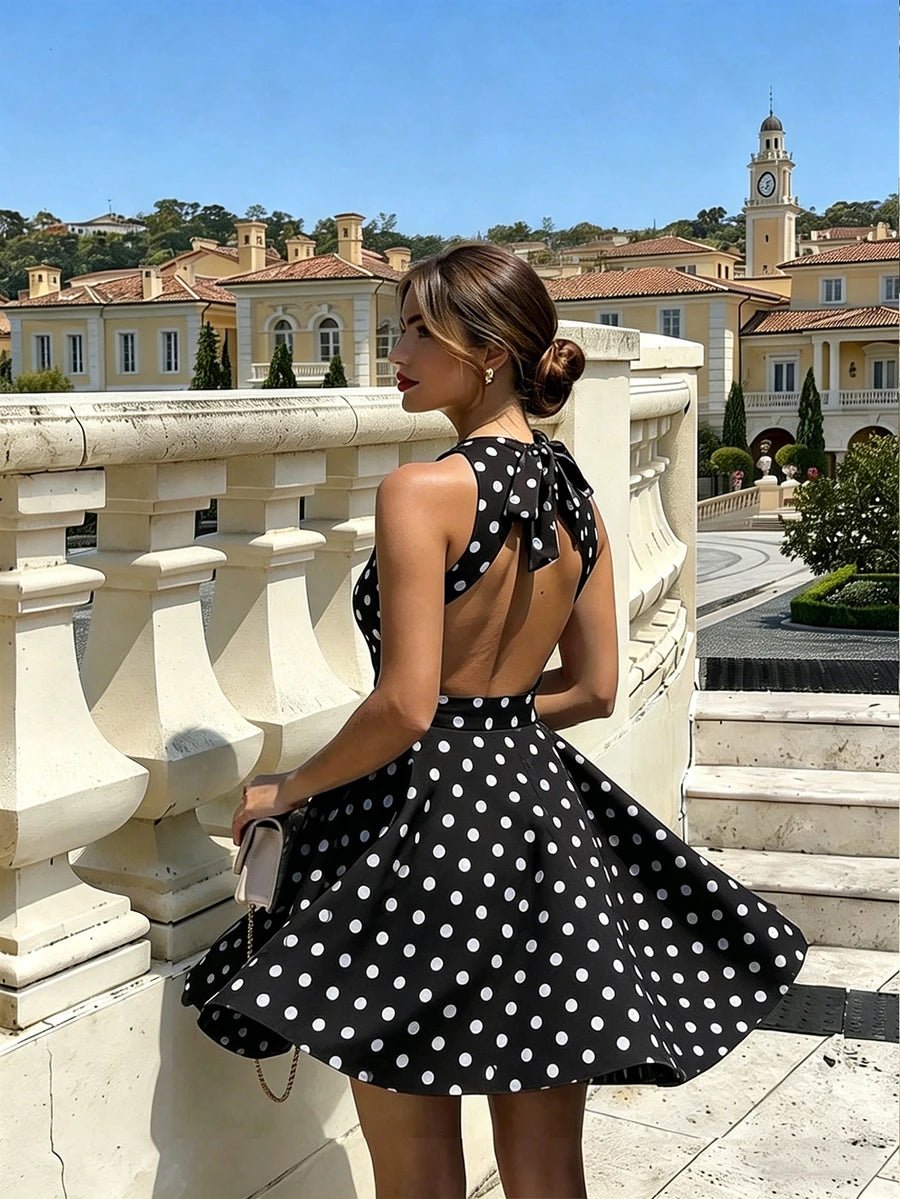 Shop a polka dot halter mini dress in coffee or blue. A chic A line summer dress for vacations, weekend getaways, and casual outings.