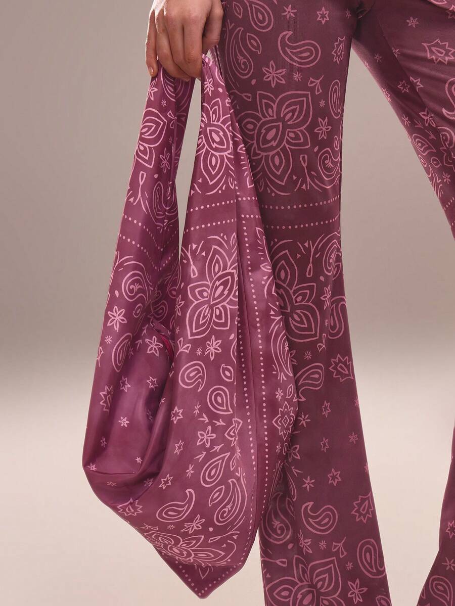 Magenta paisley bandana scarf tied as slouchy shoulder bag on model