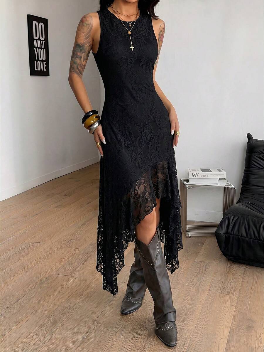 Close view of black lace dress neckline, sleeveless cut, fitted torso and sheer asymmetrical hem