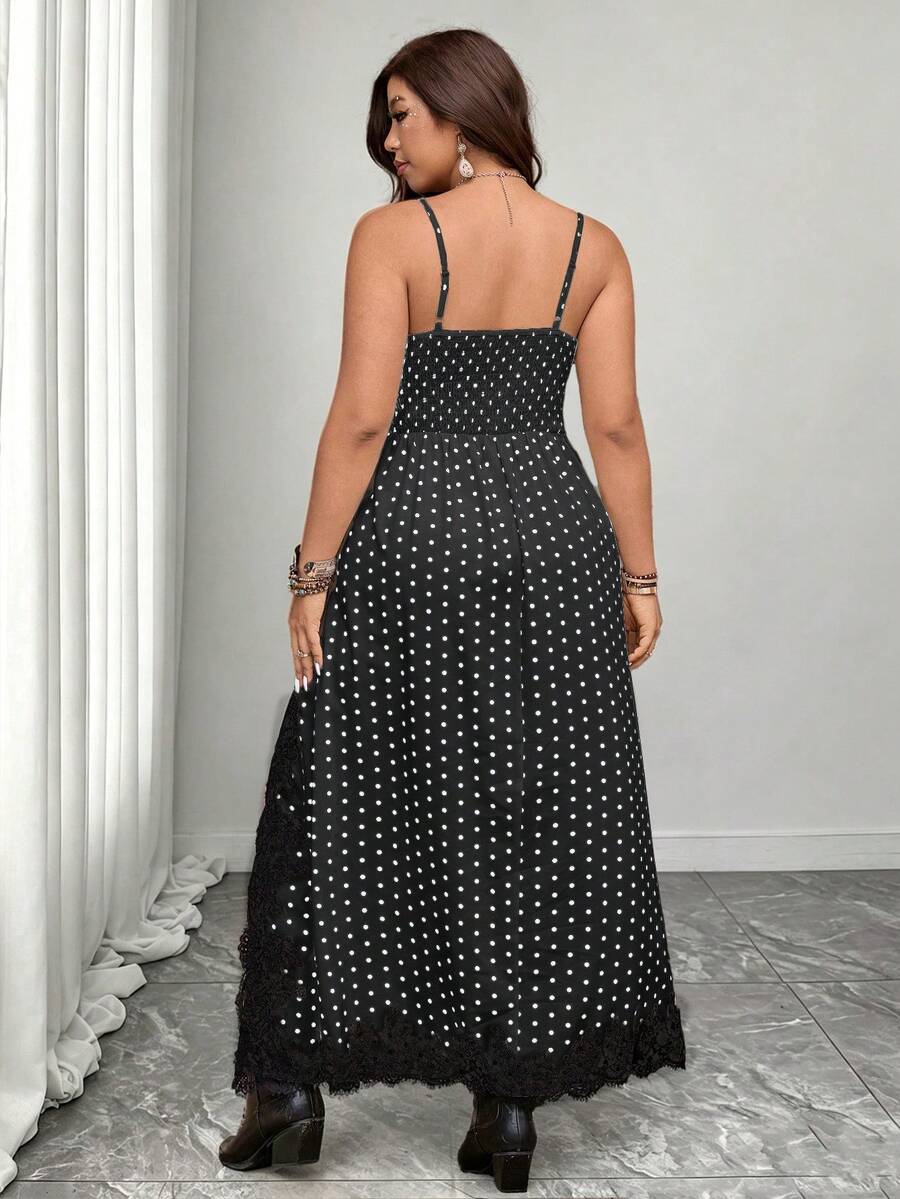 Front view of black and white polka dot lace-trim maxi dress with side slit