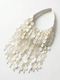 Close view of ivory sequin fringe bag with bead drops and shiny beach style