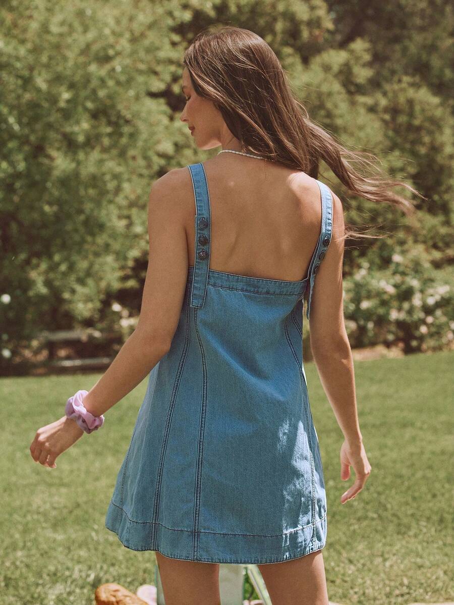 Front three-quarter view of light wash square neck denim mini dress with contrast stitching for summer outings