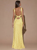 Back view of yellow with dark polka dots sleeveless deep V-neck maxi dress with crossed open back, shown for wedding and evening wear
