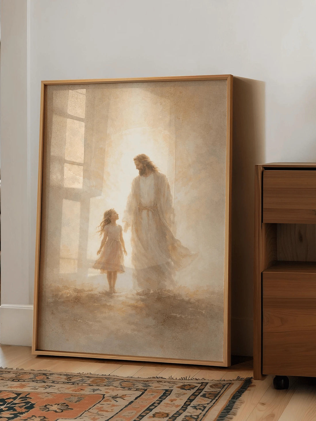 Framed Jesus and little girl canvas art close-up on a light wood chair in a sunlit room