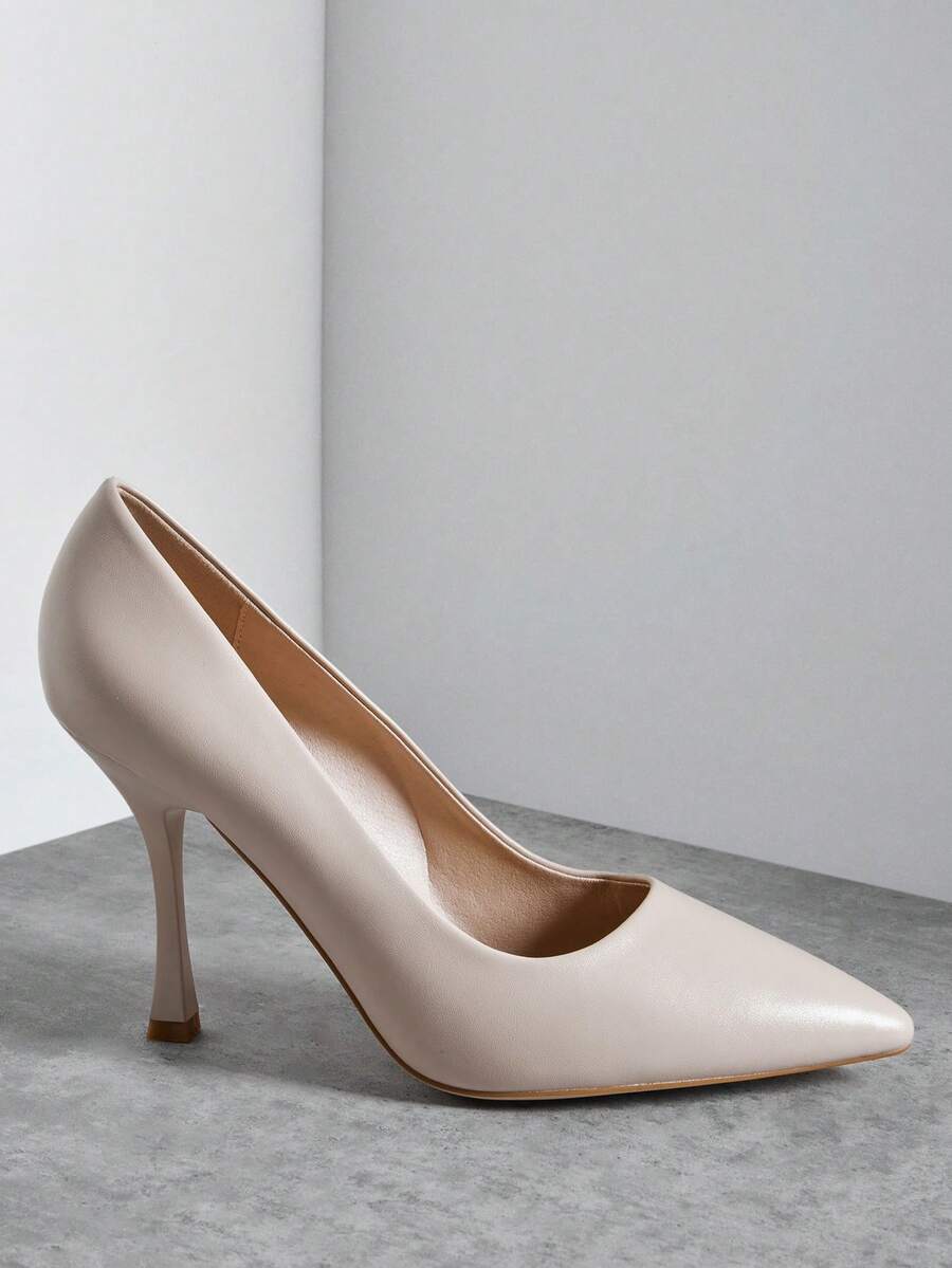Side product view of blush pointed-toe strapless stiletto court pumps with smooth finish and flared high heel