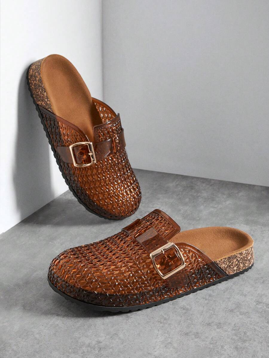 Amber-brown translucent woven clog mules with gold buckles and black soles