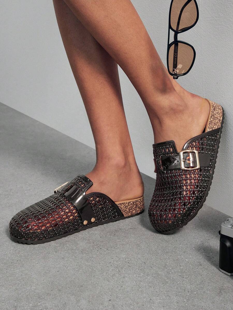 Black-brown jelly fisherman clogs worn in a side lifestyle view