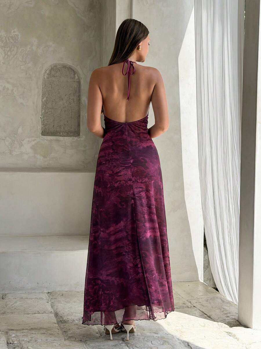 Back view of purple printed open back halter maxi dress for resort styling