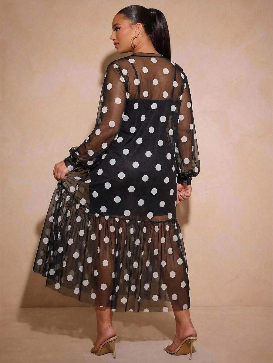 Front view of black and white polka dot long dress with sheer bishop sleeves and gathered flounce hem