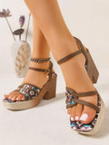 Side view of brown tribal print wedge sandal with gold buckle