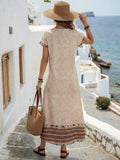Beach view of beige border print maxi dress with relaxed boho shape