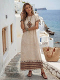 Front view of beige geometric border print maxi dress with short sleeves