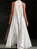 Back view of white halter back maxi dress with loose A-line silhouette
