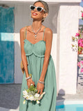 Close-up sage green ruffle bust sundress with bouquet