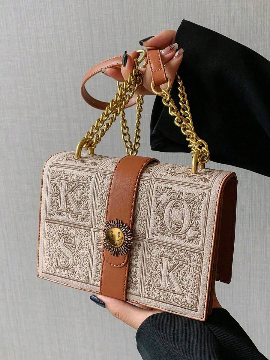 Black mini box crossbody bag with chain strap and structured rectangular shape