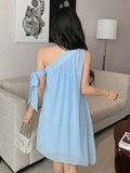 Back view of light blue one-shoulder A-line mini dress showing visible color, print, and silhouette