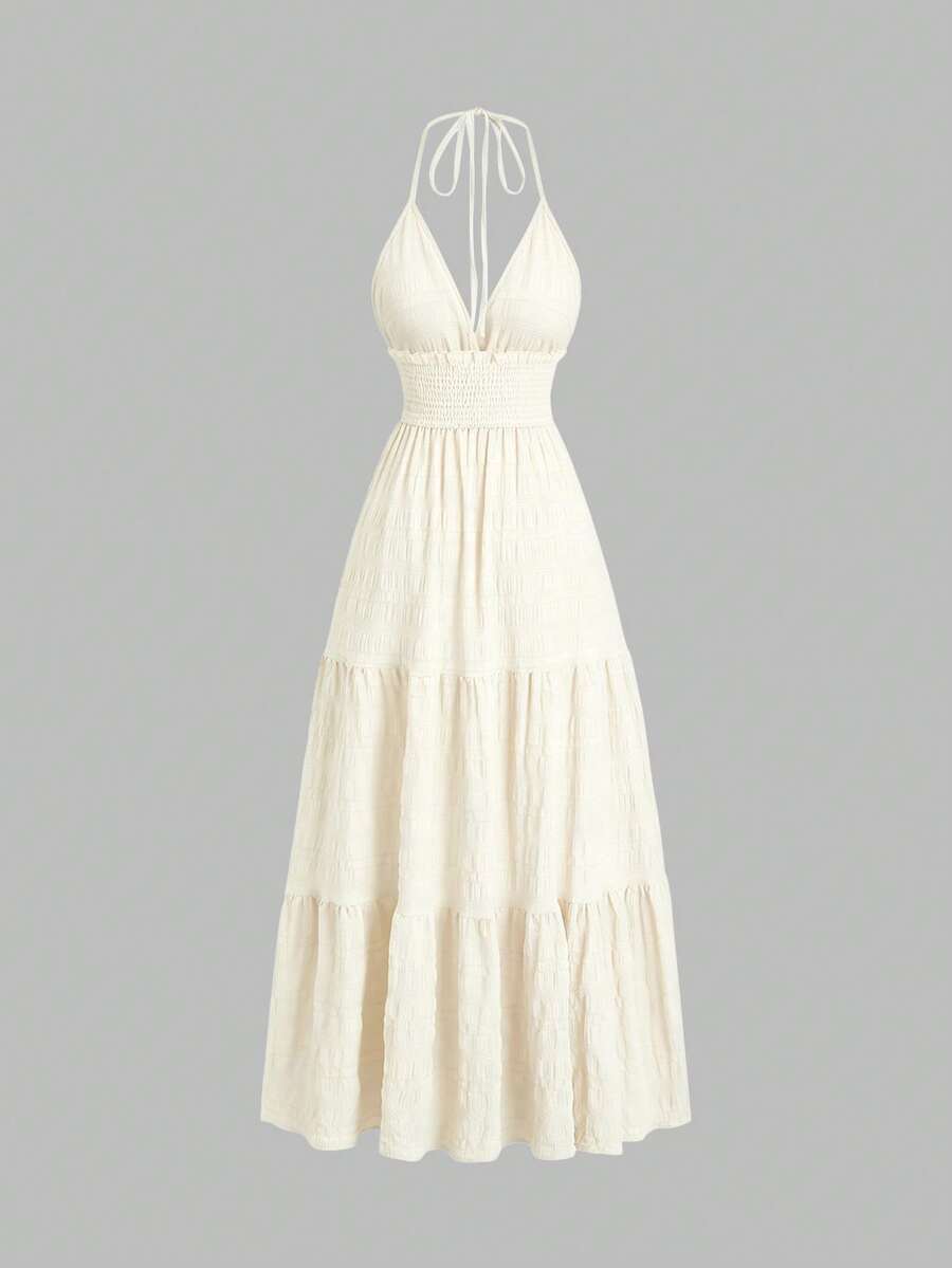Light green halter mini dress with shirred waist and tiered flared hem