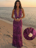 Beach view of purple printed halter maxi dress with shell waist detail
