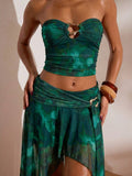 Front studio view of teal abstract print mesh bandeau crop top and flowing high-slit maxi skirt two-piece set for beach vacation styling