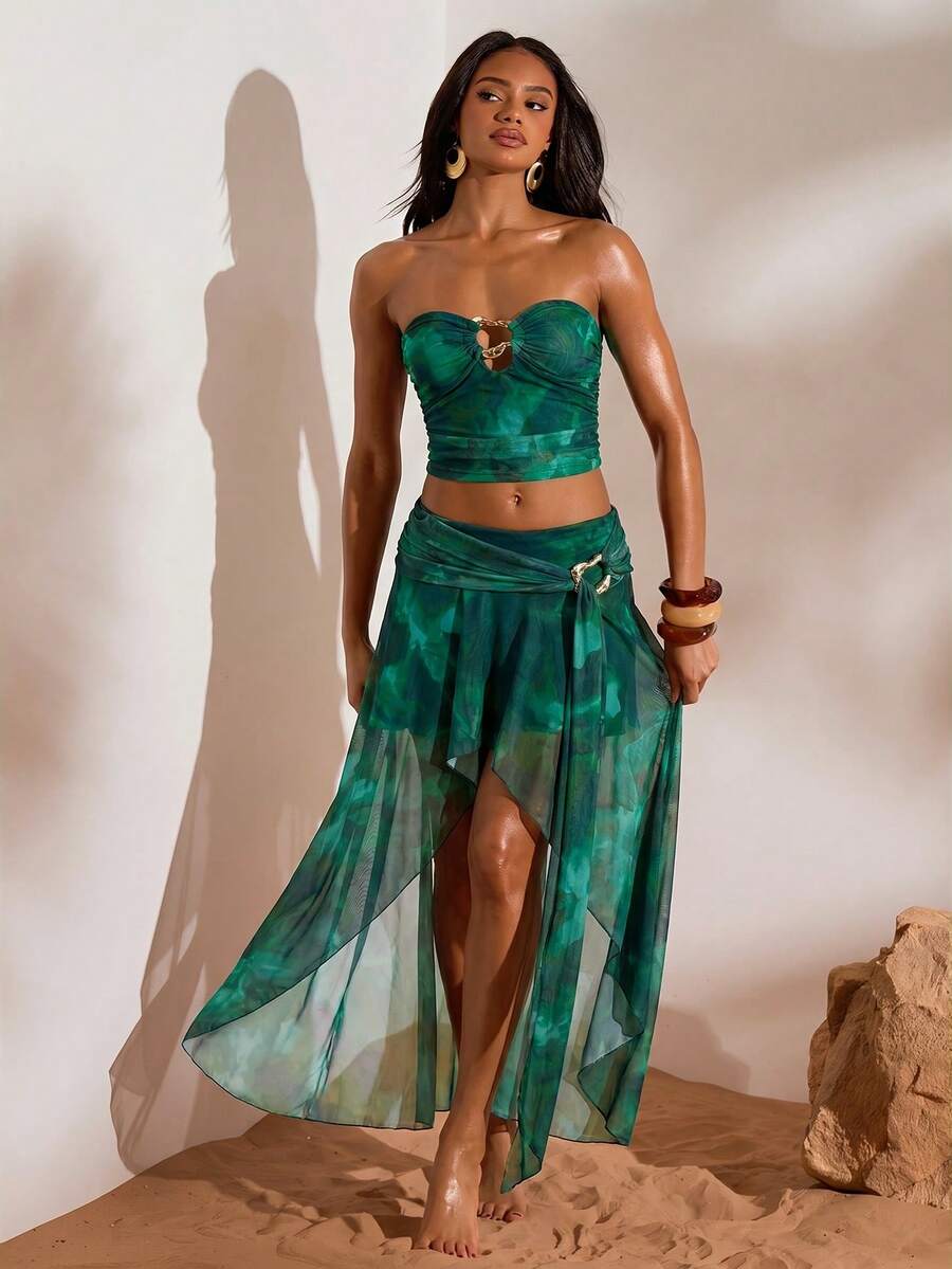 Front full view of teal abstract print mesh bandeau crop top and flowing high-slit maxi skirt two-piece set for beach vacation styling
