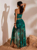 Back view of teal abstract print mesh bandeau crop top and flowing high-slit maxi skirt two-piece set for beach vacation styling