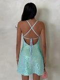 open back sequin cami mini dress with scoop neckline, spaghetti straps, crisscross tie back, fitted bodice, slight A-line mini skirt, iridescent sequin variants and orange floral print variant image 10