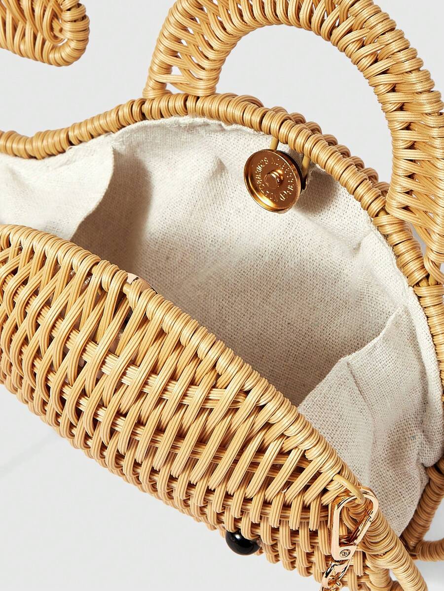 Side view of straw whale novelty handbag with rigid woven body