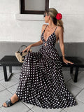 Black and white polka dot cutout waist maxi dress, seated front view