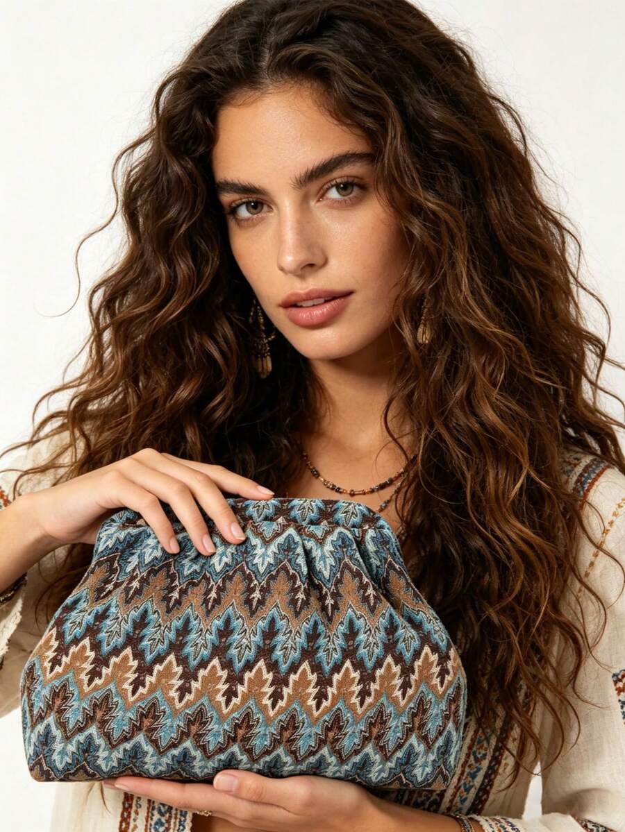 Model holding blue brown bohemian printed clutch with turquoise leaf pattern