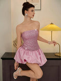Seated view of pink sequin evening gown for formal parties