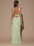 Back view of ivory sleeveless deep V-neck maxi dress with crossed open back, shown for wedding and evening wear