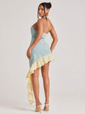 Back view of blue and yellow gingham halter bodycon mini dress with open back and cascading ruffle tail