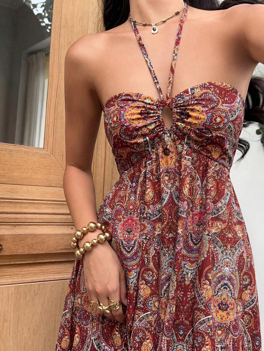 Close view rust red paisley halter maxi dress with front keyhole cutout
