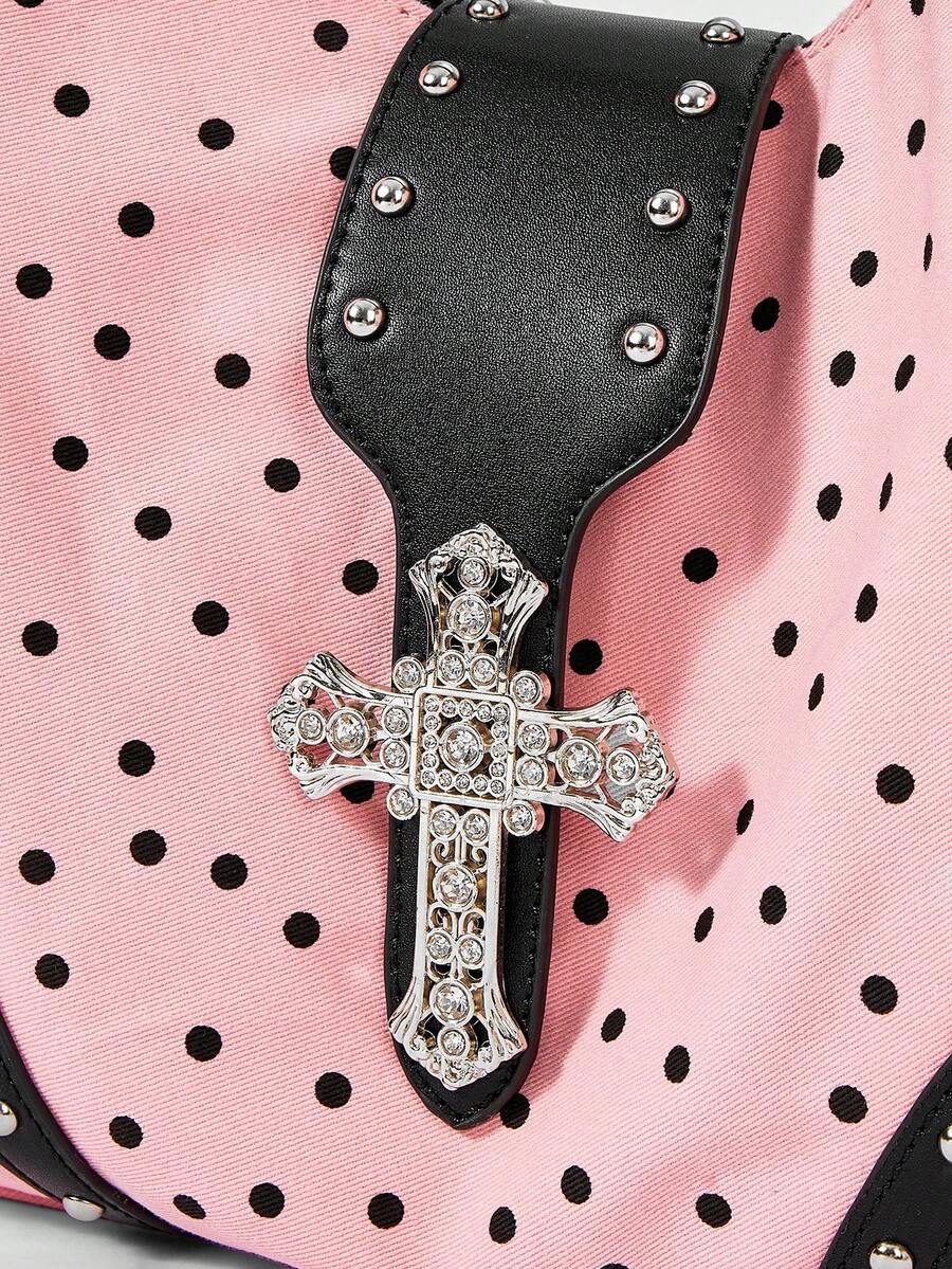 Close-up view of patterned shoulder bag hardware and handle construction