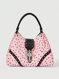 Front view of pink polka dot hobo shoulder bag with silver cross detail