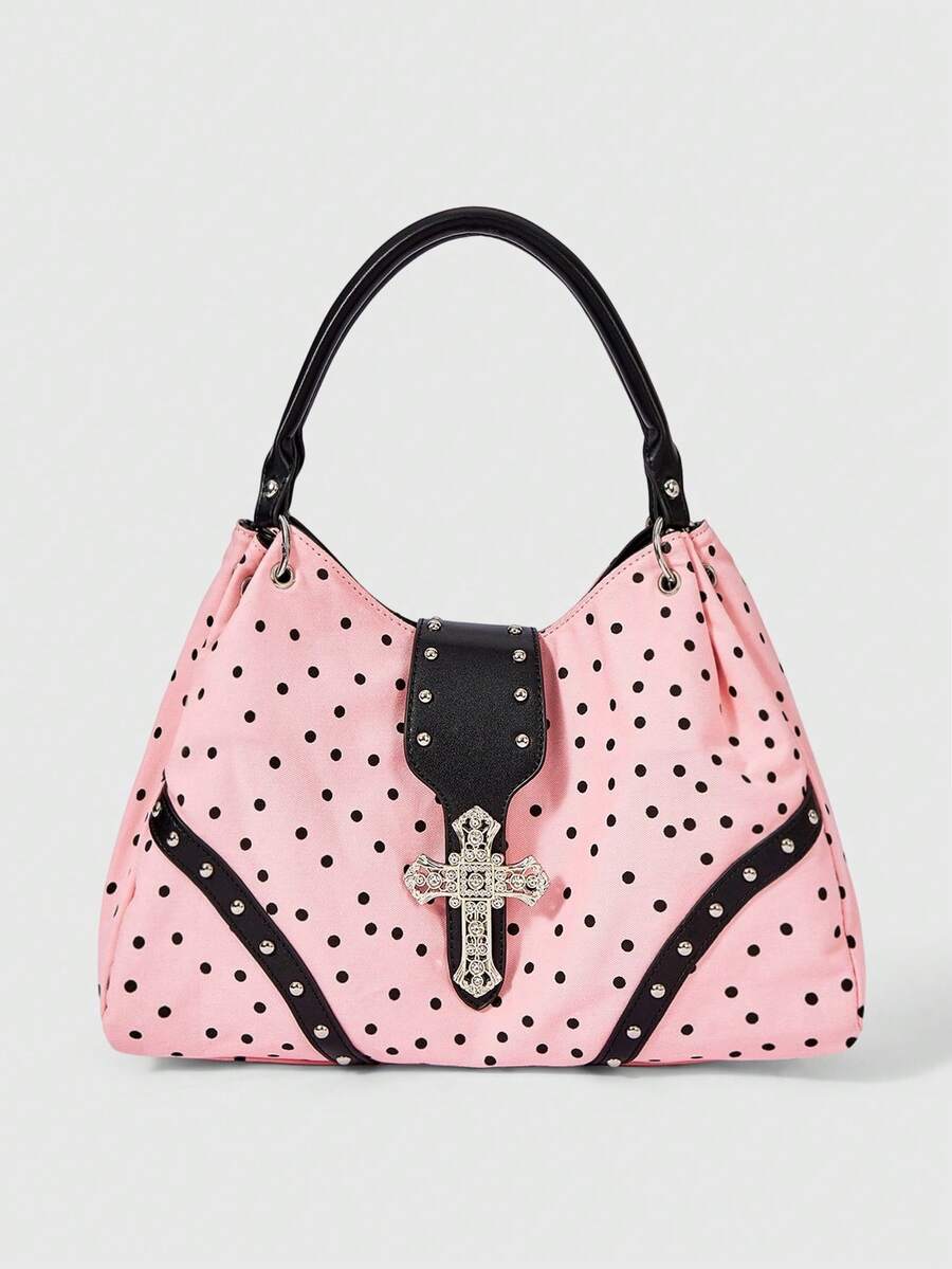 Front view of pink polka dot hobo shoulder bag with silver cross detail