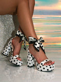 Pink variant detail view of polka dot platform sandal with bow ankle tie