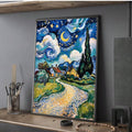 Angled shelf view of framed starry night canvas art leaning with decor objects