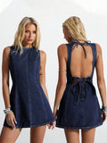 Front and back studio view of dark indigo denim mini dress with neck tie and lower back zipper