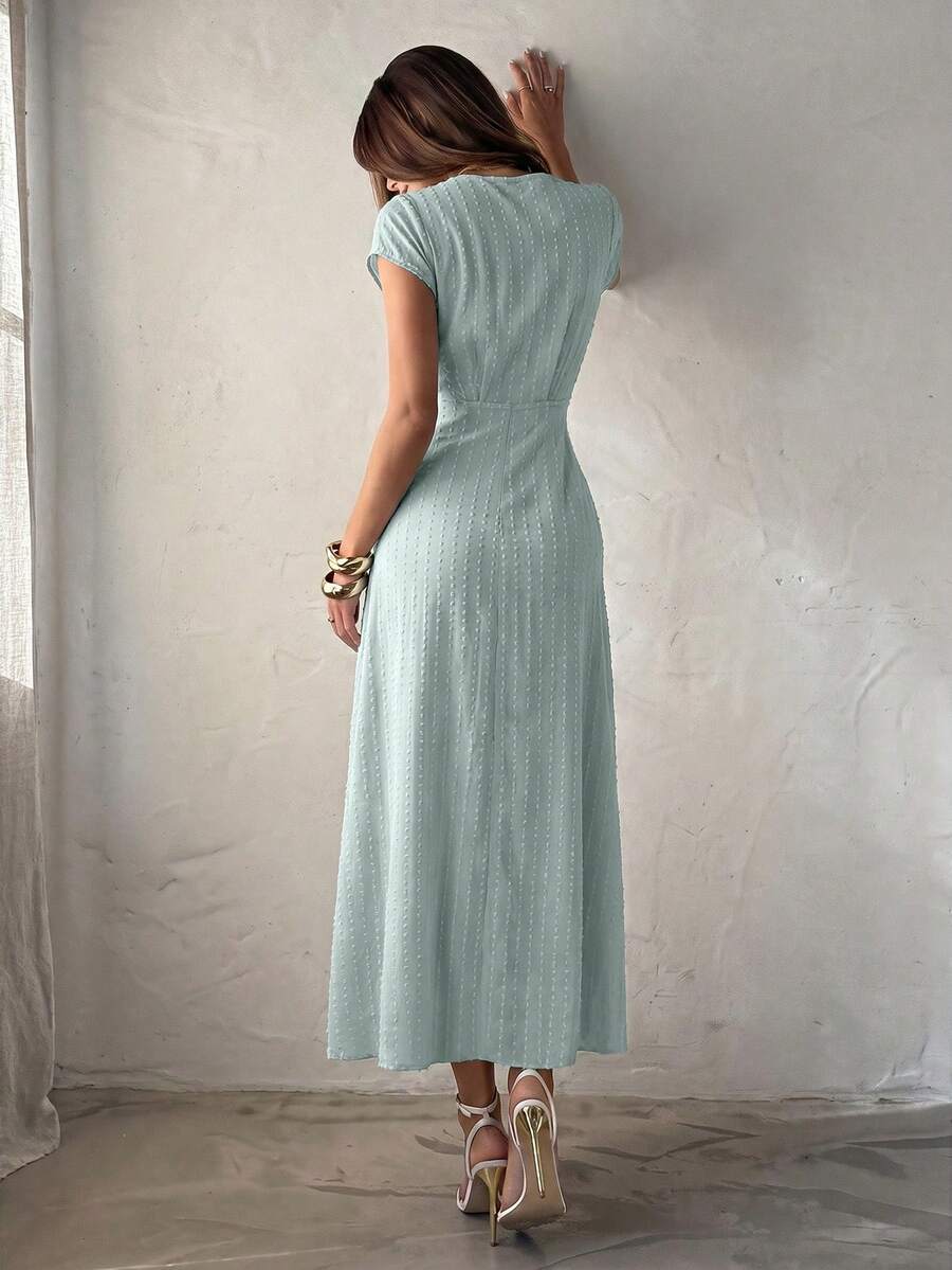 Front detail view of mint green ruched V-neck maxi dress with raised dotted texture