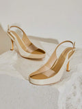 Ivory transparent-vamp slingback stilettos on a textured pedestal